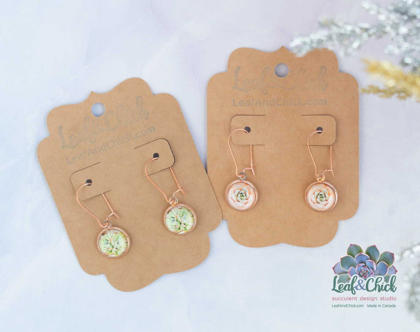 two pairs of rose gold stainless steel earrings carded