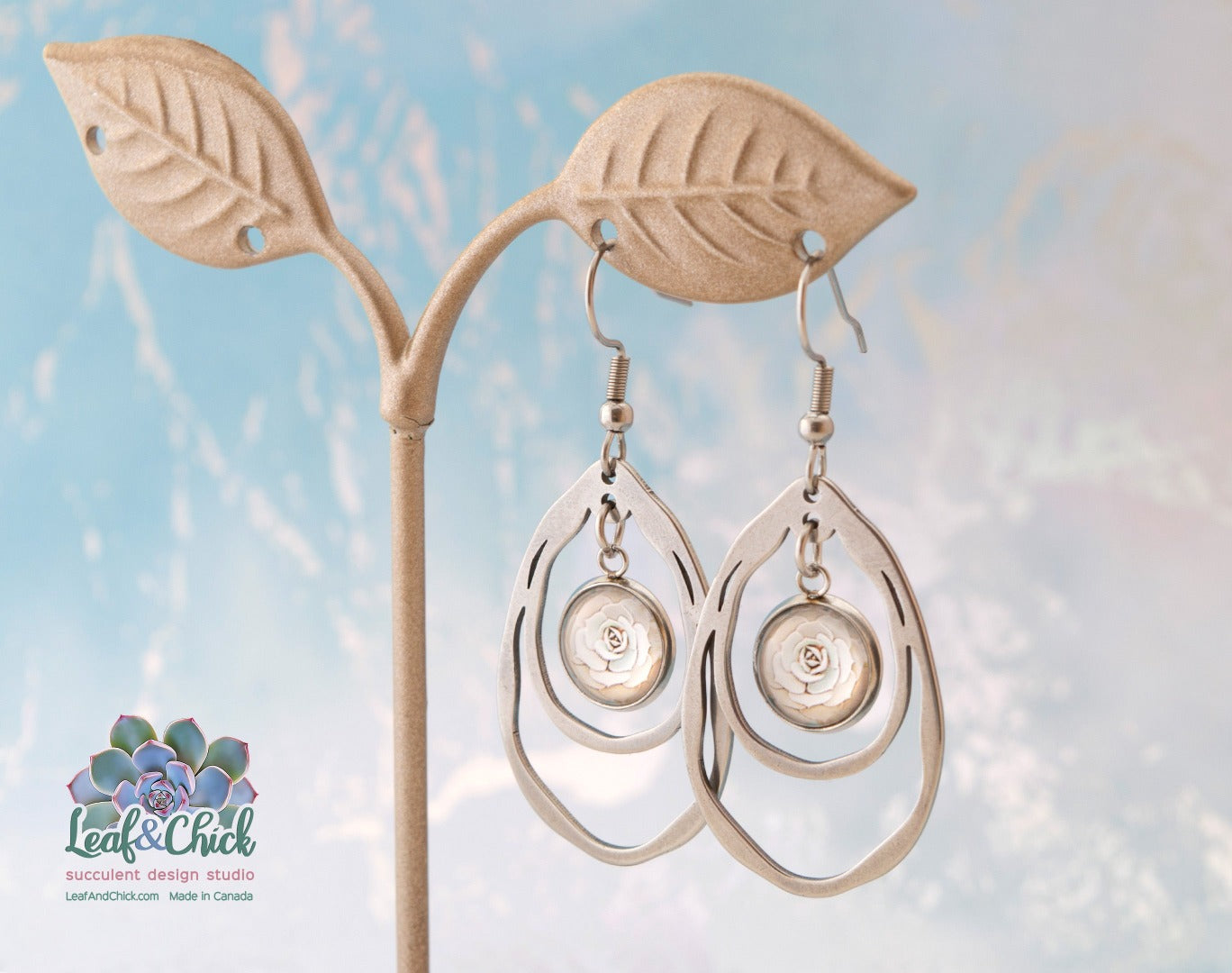 large stainless steel ripple teardrop shaped earrings with delicate succulent art