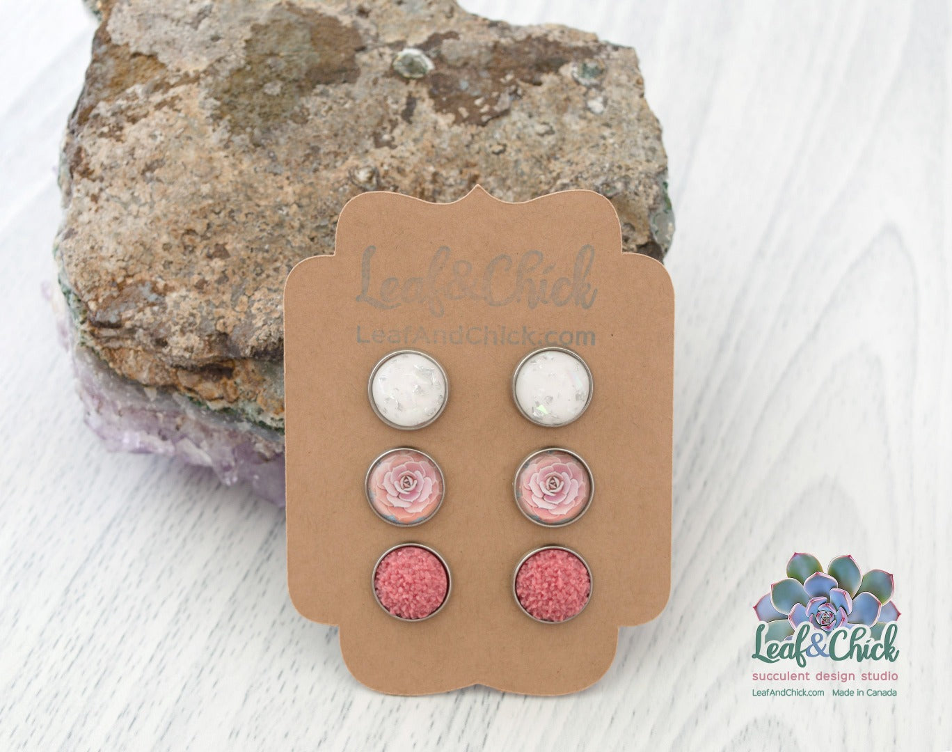 three pairs of stud earrings in sparkles and pinks