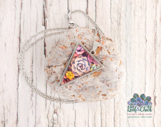 a triangle pendant with colourful succulent art