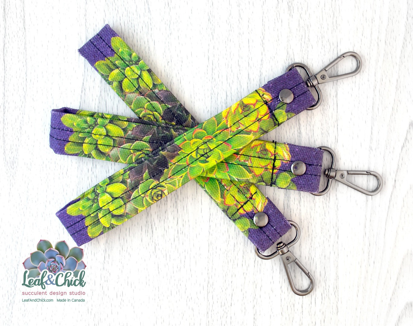 succulent key fobs in purples and greens with black metal swivel hooks