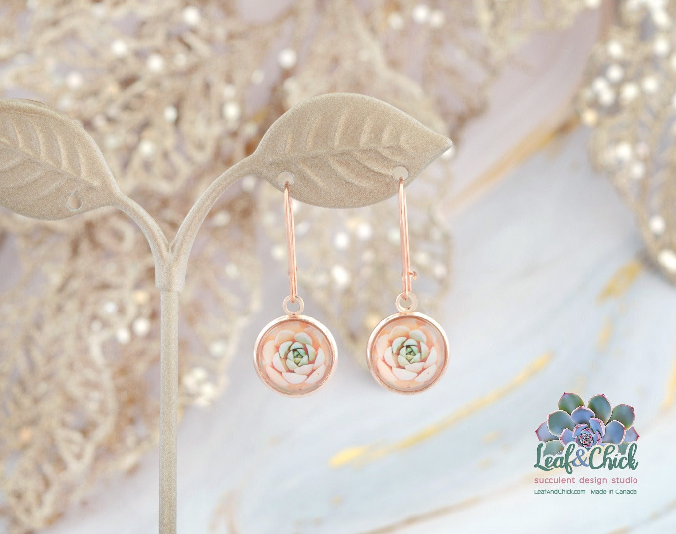 rose gold hoop earrings hanging with pink succulent art