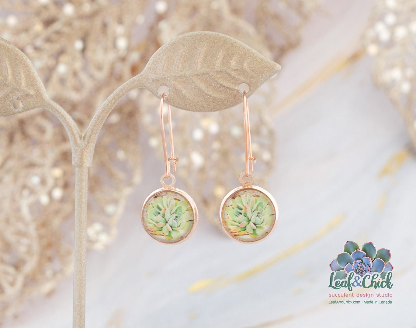 rose gold hoop earrings hanging with green succulent art