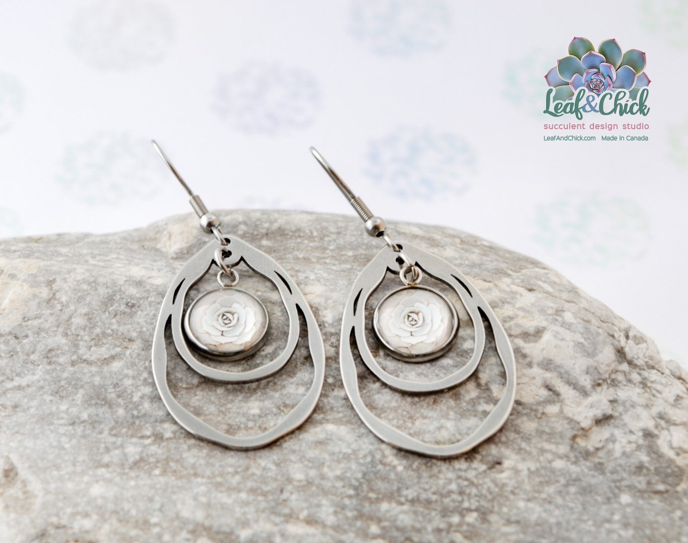 ripple teardrop shaped earrings with succulent art suspended in the middle