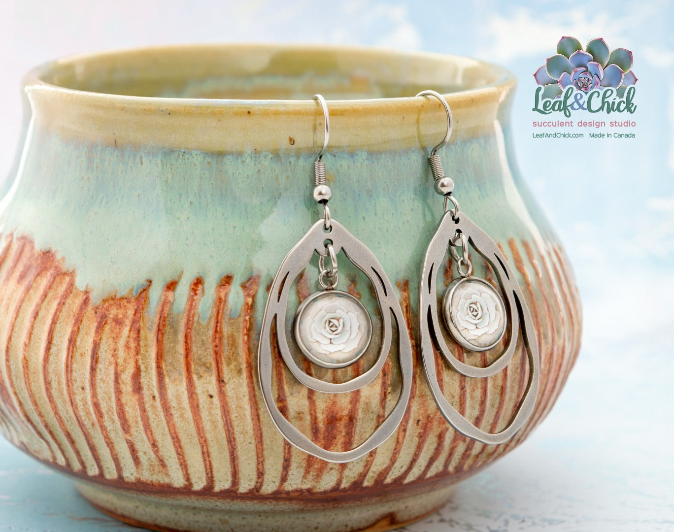 large stainless steel earrings hanging off the side of a bowl