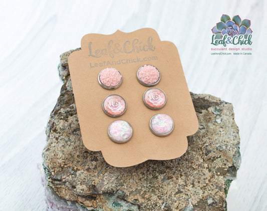 a set of three stainless steel stud earrings