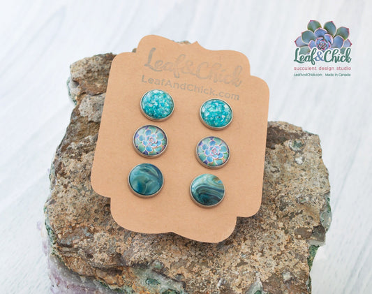 a 3 pack of stainless steel stud earrings in blues