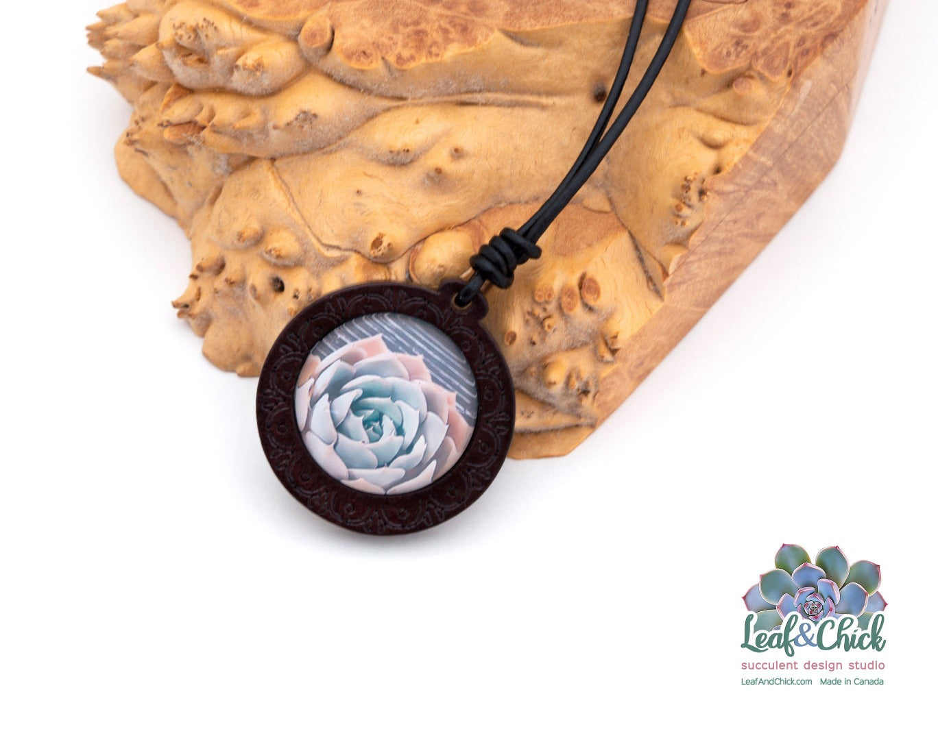 close up of wood necklace with succulent art